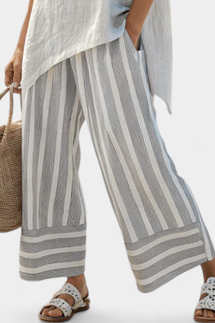 Completo Daisy di Blusa Asimmetrica e Pantaloni a Righe per uno Stile Moderno ed Elegante